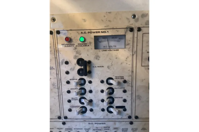 Slide: The Image of 1998 Cruisers 3375 Espirit electrical panel with switches and voltage meter. - 32