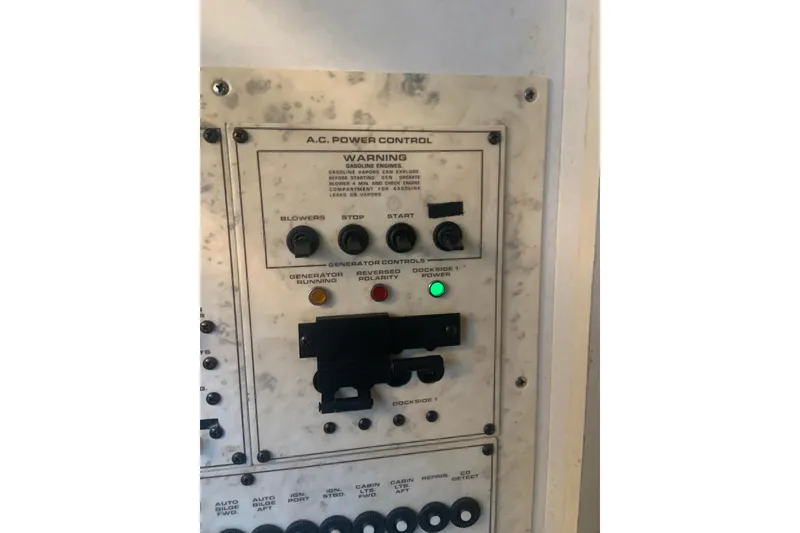 Slide: The Image of Control panel of a 1998 Cruisers 3375 Espirit boat, featuring A.C. power controls. - 33