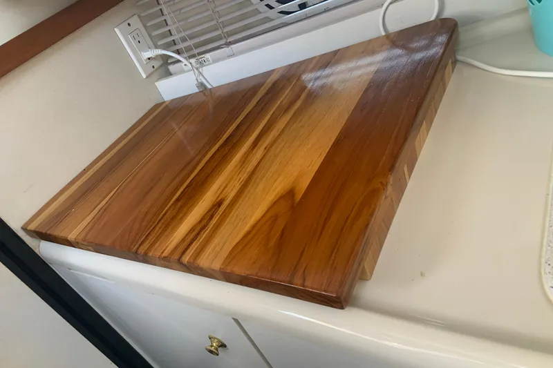Slide: The Image of Polished wooden cutting board on a 1998 Cruisers 3375 Espirit boat kitchen counter. - 36