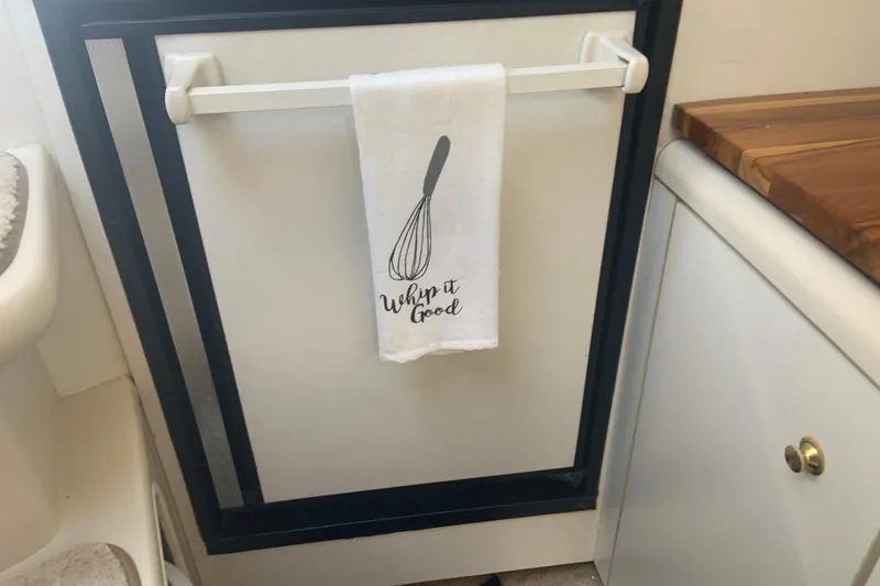 Slide: The Image of Towel with whisk design and "Whip it Good" text in 1998 Cruisers 3375 Espirit kitchen. - 37