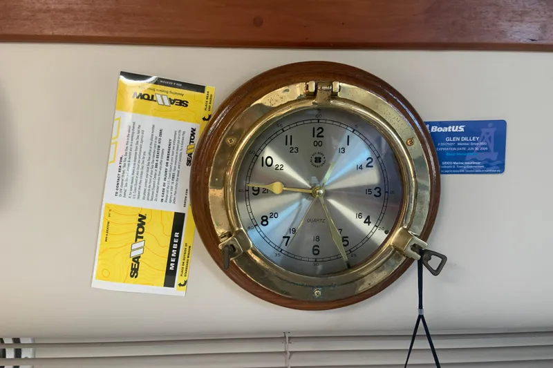 Slide: The Image of Brass nautical clock on 1998 Cruisers 3375 Espirit boat with Sea Tow membership card. - 42
