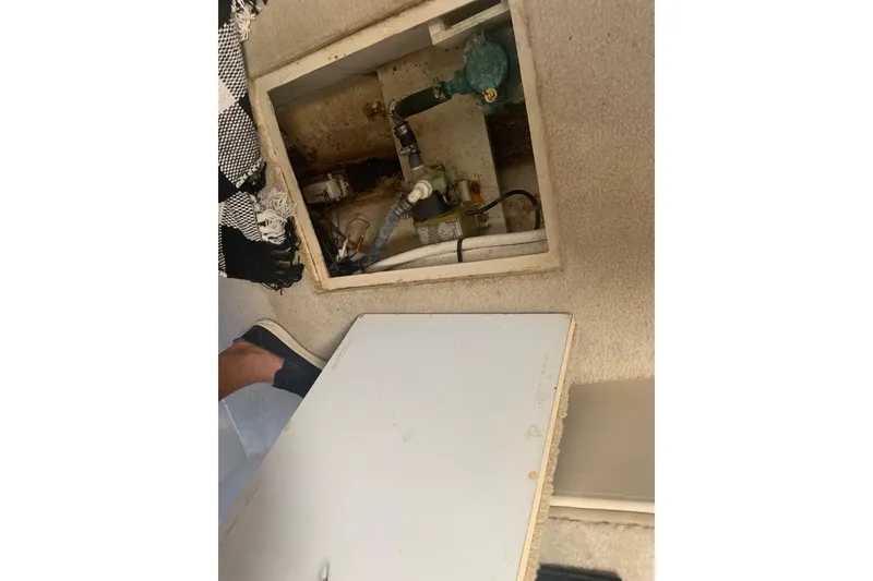 Slide: The Image of 1998 Cruisers 3375 Espirit boat interior compartment with exposed plumbing and wiring. - 44
