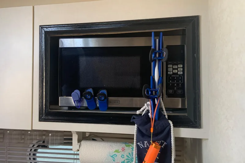 Slide: The Image of Built-in microwave in 1998 Cruisers 3375 Espirit boat kitchen, with clips and accessories. - 46
