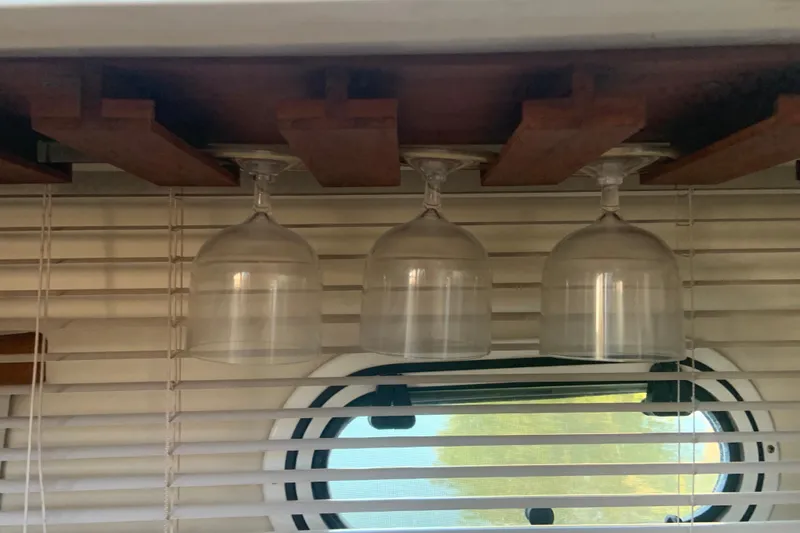 Slide: The Image of Hanging wine glasses in 1998 Cruisers 3375 Espirit boat interior with window blinds. - 47