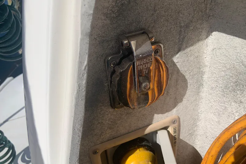 Slide: The Image of 1998 Cruisers 3375 Espirit boat power outlet with protective cover in sunlight. - 49