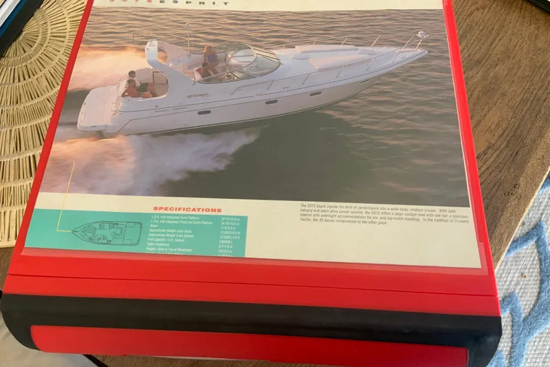 Slide: The Image of 1998 Cruisers 3375 Espirit boat brochure on a wooden table. - 52