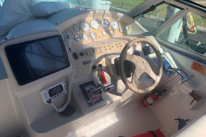 Slide: The Image of 1998 Cruisers 3375 Espirit boat cockpit with steering wheel, gauges, and navigation equipment. - 8