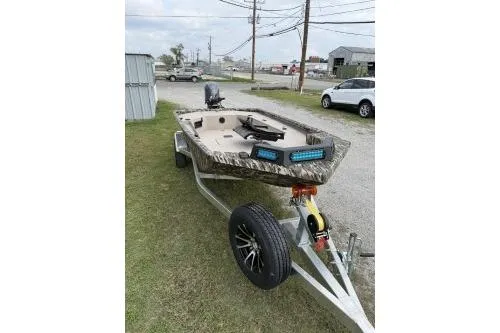 Slide: The Image of 2026 Avid 16 Commander boat on trailer, parked outdoors. - 4