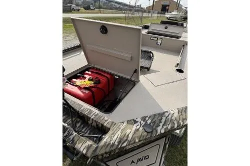 Slide: The Image of 2026 Avid 16 Commander boat with open storage compartment and camouflage design. - 7