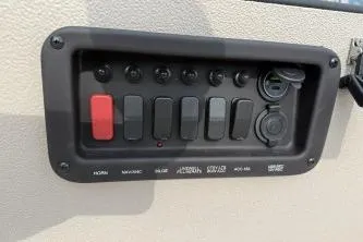 Slide: The Image of Control panel of 2026 Avid 16 Commander boat with switches and ports. - 8