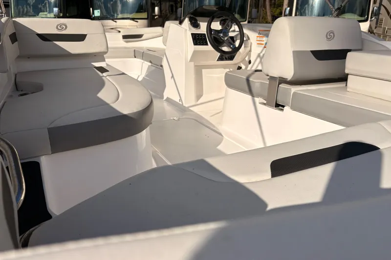 Slide: The Image of 2022 Hurricane SunDeck Sport 185 OB interior with white and gray seating, steering console. - 11