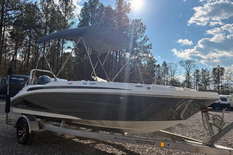 Slide: The Image of 2022 Hurricane SunDeck Sport 185 OB boat on trailer under blue sky. - 5
