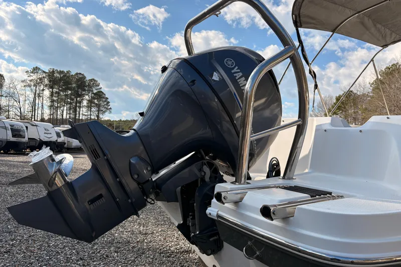 Slide: The Image of 2022 Hurricane SunDeck Sport 185 OB boat with Yamaha outboard motor, parked outdoors. - 9