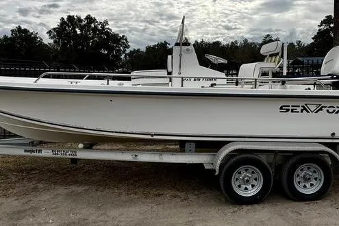 The Image of 2003 Sea Fox 215 Bay Fisher boat on trailer, side view, outdoors. - 0