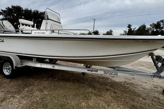 Slide: The Image of 2003 Sea Fox 215 Bay Fisher boat on trailer, side view, outdoors. - 2