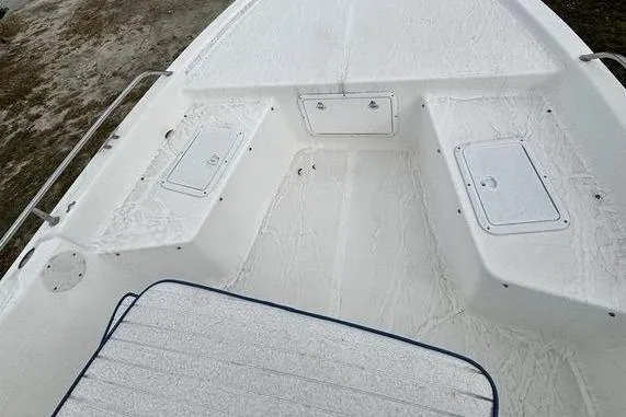 Slide: The Image of 2003 Sea Fox 215 Bay Fisher boat deck with storage compartments and seating area. - 5