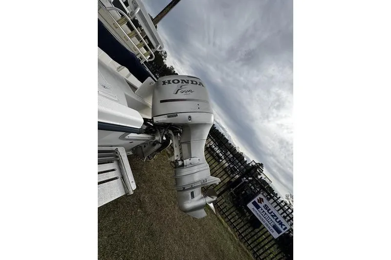 Slide: The Image of 2003 Sea Fox 215 Bay Fisher with Honda outboard motor, displayed outdoors. - 7