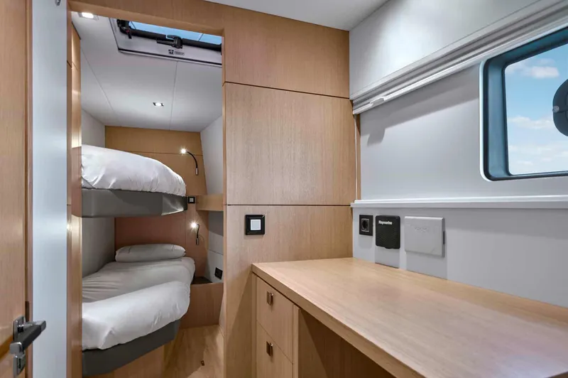 Slide: The Image of 2025 Privilege Signature 580 cabin with bunk beds and wooden interior design. - 46
