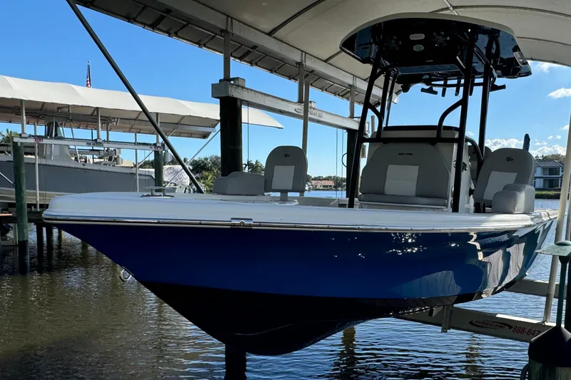 The Image of 2019 Sea Pro 248 Bay boat docked under a canopy on a sunny day. - 0