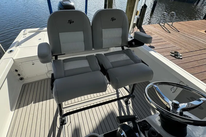 Slide: The Image of 2019 Sea Pro 248 Bay boat interior with dual seats and steering wheel. - 10