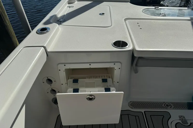 Slide: The Image of 2019 Sea Pro 248 Bay boat interior with storage compartment and cup holder. - 12