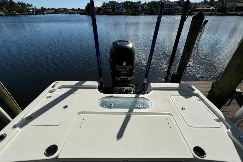 Slide: The Image of 2019 Sea Pro 248 Bay boat docked by a serene waterfront. - 5