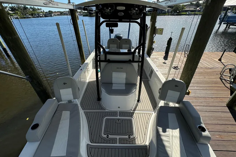 Slide: The Image of 2019 Sea Pro 248 Bay boat docked, featuring spacious seating and modern design. - 9