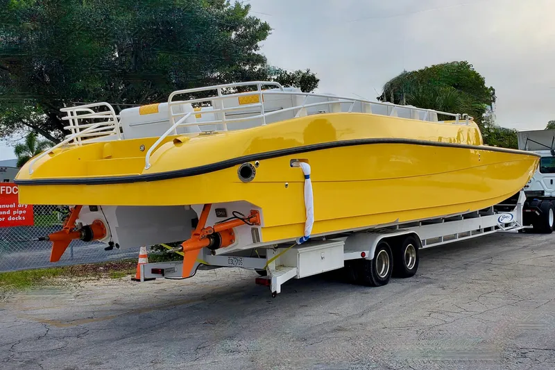 Slide: The Image of Yellow 2005 Thriller Powerboats Super Cat 55 on trailer, parked outdoors. - 11