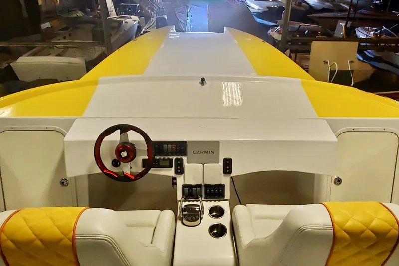 Slide: The Image of Interior view of 2005 Thriller Powerboats Super Cat 55 with yellow accents and Garmin controls. - 16