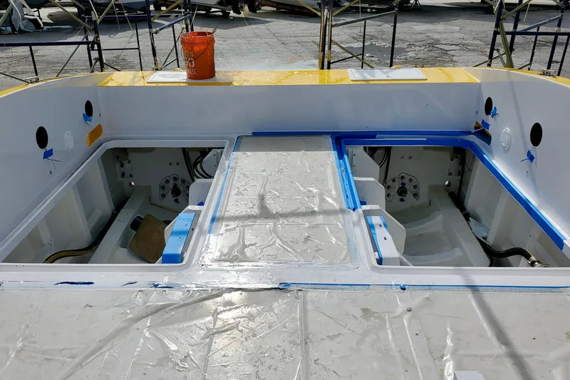 Slide: The Image of 2005 Thriller Powerboats Super Cat 55 engine compartment under maintenance, with protective coverings. - 17