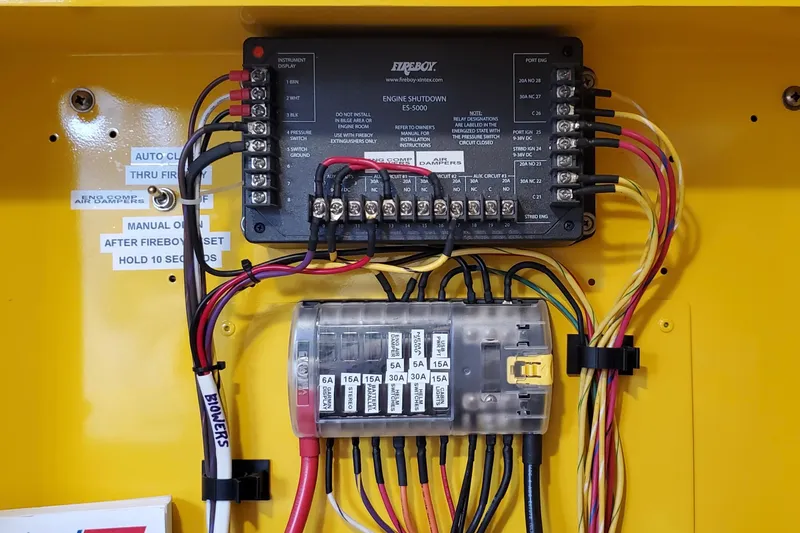 Slide: The Image of Electrical panel of a 2005 Thriller Powerboats Super Cat 55, featuring wiring and circuit breakers. - 25