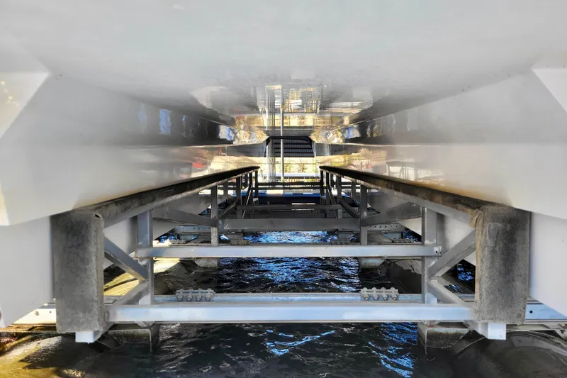 Slide: The Image of Underneath view of a 2005 Thriller Powerboats Super Cat 55 on a boat lift. - 28