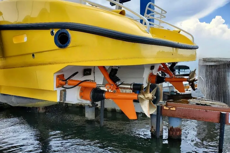 Slide: The Image of Yellow 2005 Thriller Powerboats Super Cat 55 with visible propellers and stern details. - 7