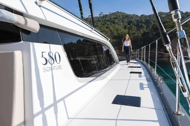 Slide: The Image of Luxury Privilege Signature 580 yacht, 2025 model, with person walking on deck. - 13