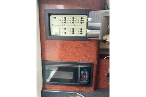 Slide: The Image of 1996 Donzi 275 LXC interior control panel and microwave setup. - 13