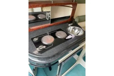 Slide: The Image of 1996 Donzi 275 LXC boat kitchenette with stove and sink. - 14