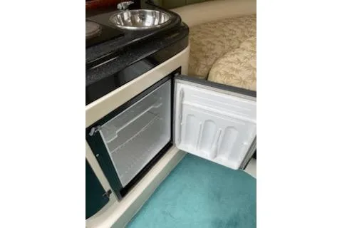 Slide: The Image of 1996 Donzi 275 LXC boat interior with open mini fridge and sink. - 15