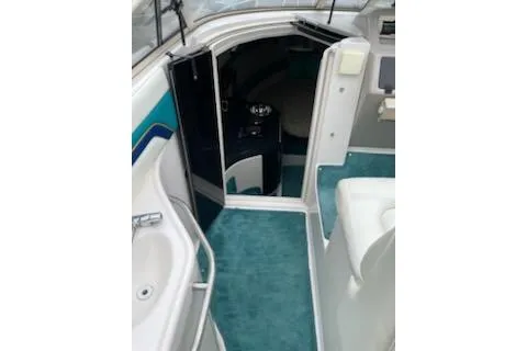 Slide: The Image of 1996 Donzi 275 LXC boat interior with teal carpet and white seating. - 8