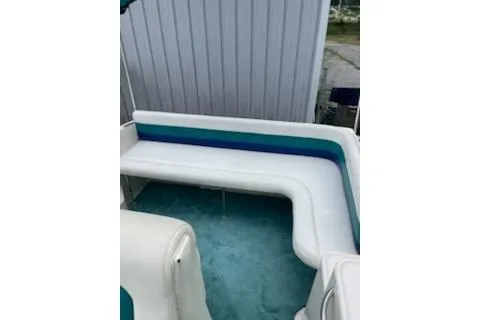 Slide: The Image of 1996 Donzi 275 LXC boat interior with white and teal seating. - 9