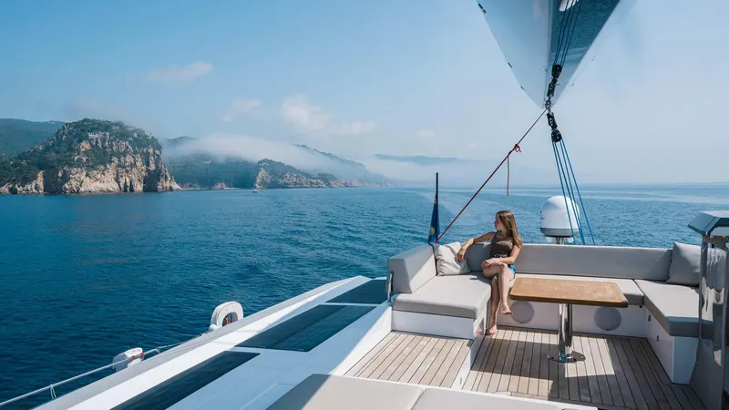 Slide: The Image of Luxury sailing on 2025 Privilege Signature 580 yacht, scenic coastal view. - 19