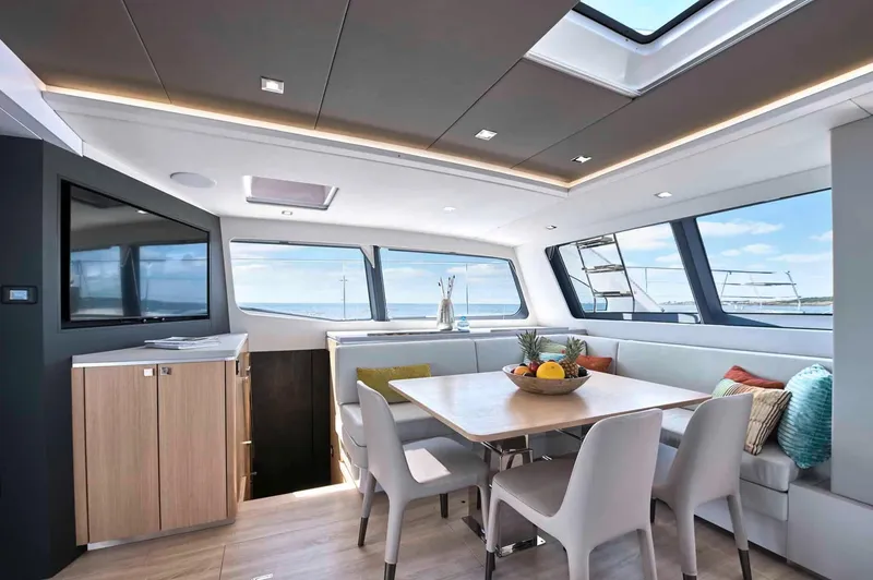 Slide: The Image of Luxurious interior of 2025 Privilege Signature 580 yacht with modern dining area and panoramic windows. - 32
