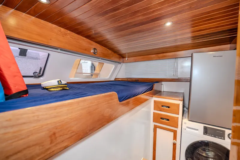 Slide: The Image of 1973 American Marine Alaskan 53 cabin with wooden interior, bunk bed, and appliances. - 11