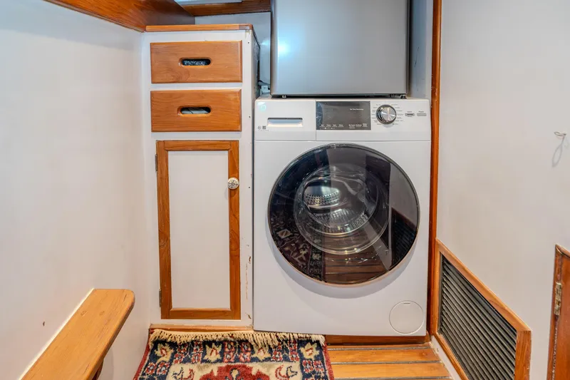 Slide: The Image of Laundry area in 1973 American Marine Alaskan 53 yacht with washer and wooden cabinetry. - 12
