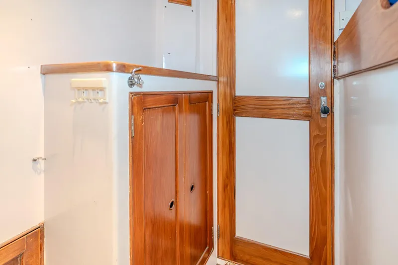 Slide: The Image of Interior of 1973 American Marine Alaskan 53 yacht with wooden cabinetry and door. - 13