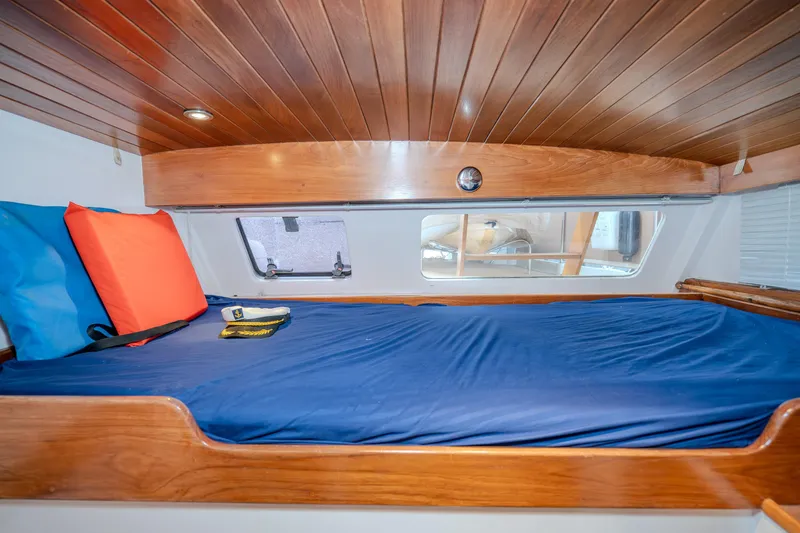 Slide: The Image of Cozy cabin bed with blue bedding in 1973 American Marine Alaskan 53 yacht. - 14