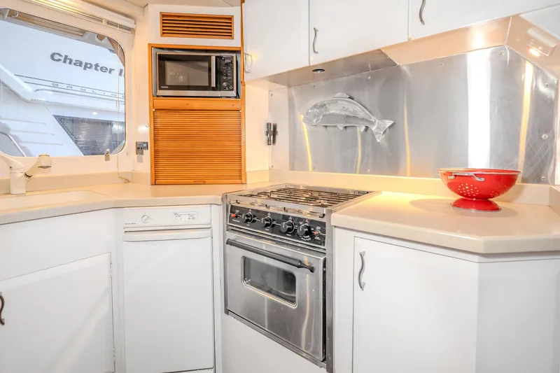 Slide: The Image of 1973 American Marine Alaskan 53 yacht kitchen with stove, microwave, and fish decor. - 18
