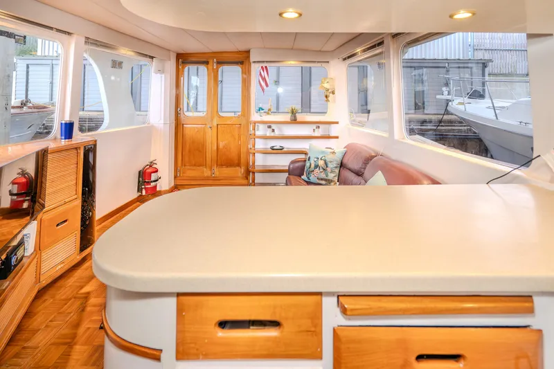 Slide: The Image of Interior of 1973 American Marine Alaskan 53 yacht with wooden accents and seating area. - 19