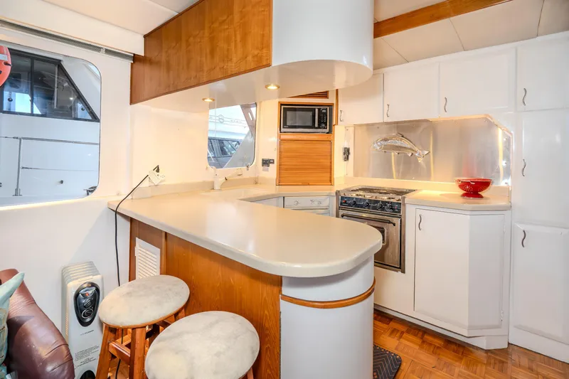 Slide: The Image of 1973 American Marine Alaskan 53 yacht kitchen with modern appliances and wooden accents. - 21