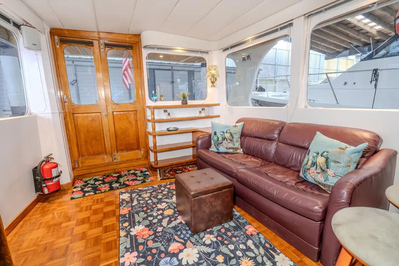 Slide: The Image of Interior of 1973 American Marine Alaskan 53 yacht with leather sofa and decorative pillows. - 22