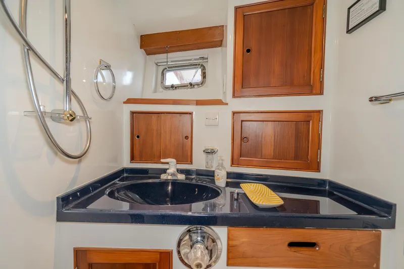 Slide: The Image of 1973 American Marine Alaskan 53 yacht bathroom with wooden cabinets and modern fixtures. - 30